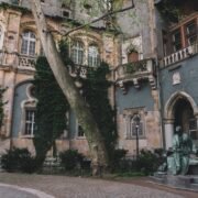 an old building with a statue in front of it