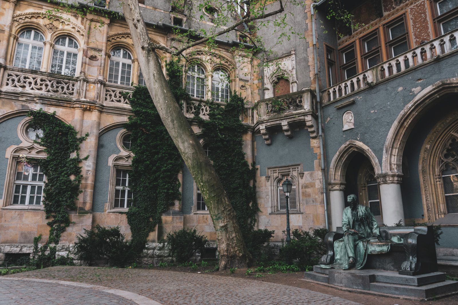 an old building with a statue in front of it