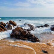 brown rocky shore under blue sky during daytime